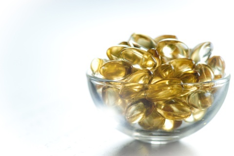 Fish oil capsules in a small glass bowl
